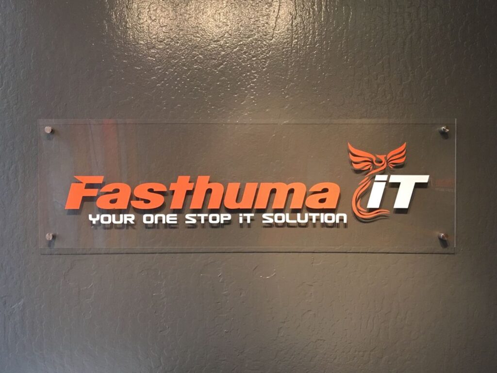 Fasthuma iT "Your one stop IT solution" logo sign on the office wall